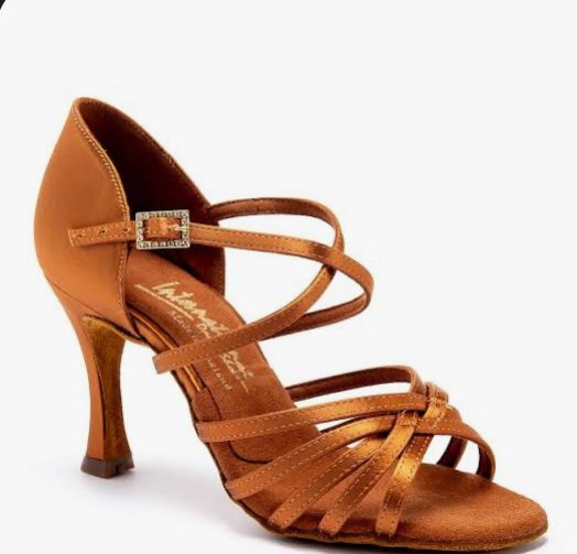 A tan suede Latin dance shoe with a low heel and ankle strap